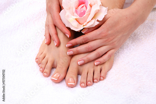 pedicure on legs and beautiful manicure hands closeup