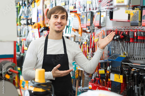 male seller posing at tooling section of household store