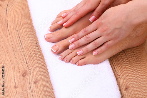 pedicure on legs and beautiful manicure hands closeup