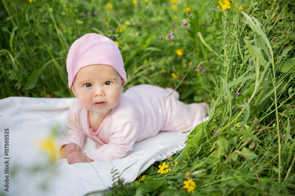 Baby girl crawling on the grass Baby girl crawling on the grass