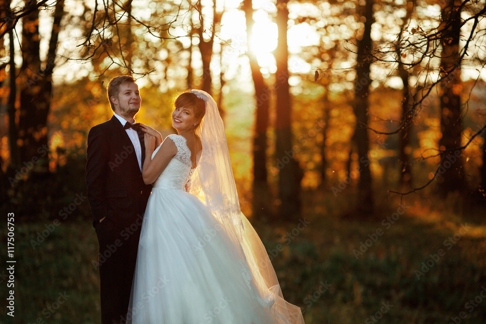 The brides stand  in the park