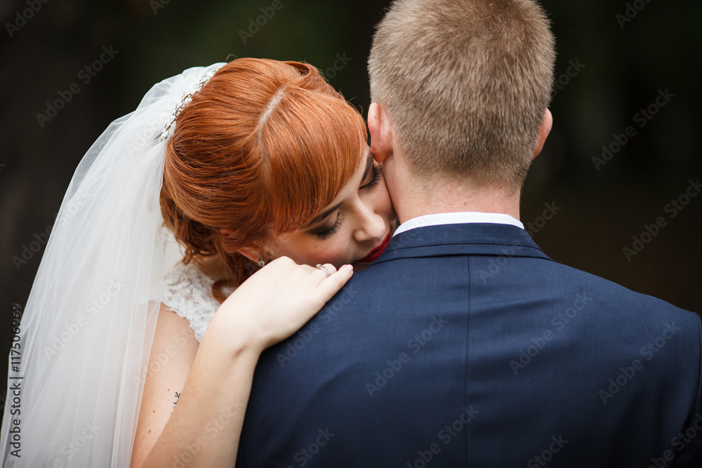 The lovely couple in love embracing in the park The lovely couple in love embracing in the park
