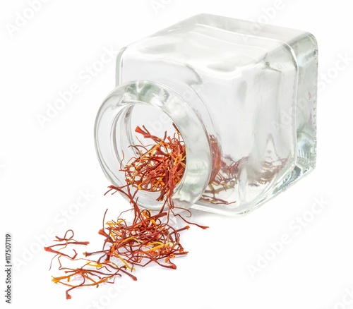 A jar of saffron spice on a white background