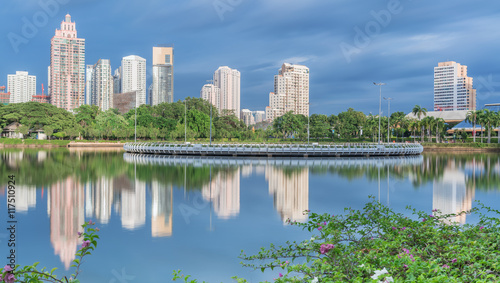 Long exposure Cityscape of Benchakitti park , green lung of Bangkok , in the evening with reflection , Thailand 