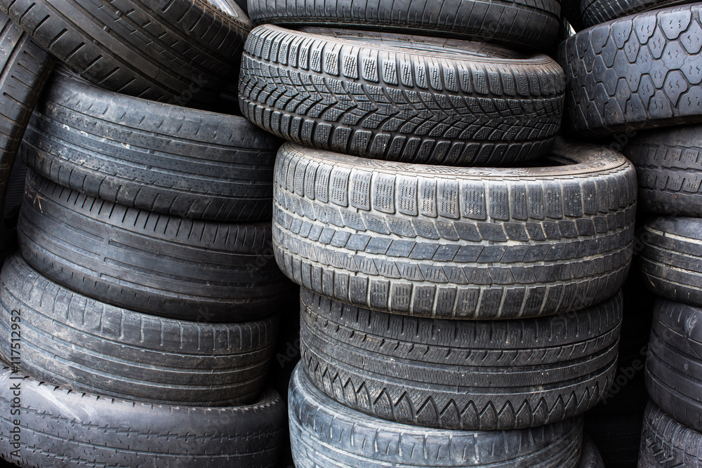 Tires for sale at a tire store - stacks of old used tires Tires for sale at a tire store - stacks of old used tires