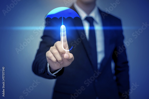 Close up of businessman touching umbrella icon, business securit