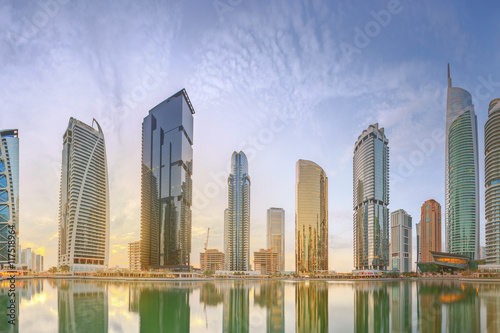 Panoramic view of Business bay and Lake Tower, reflection in a river, Dubai UAE