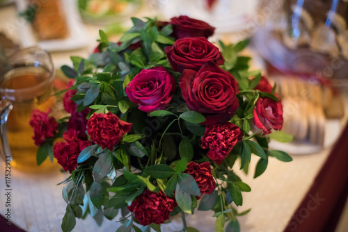 The vase with roses on the wedding table