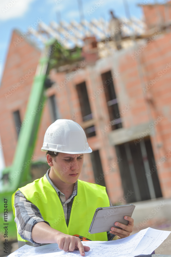 Foreman using digital tablet on construction site Foreman using digital tablet on construction site