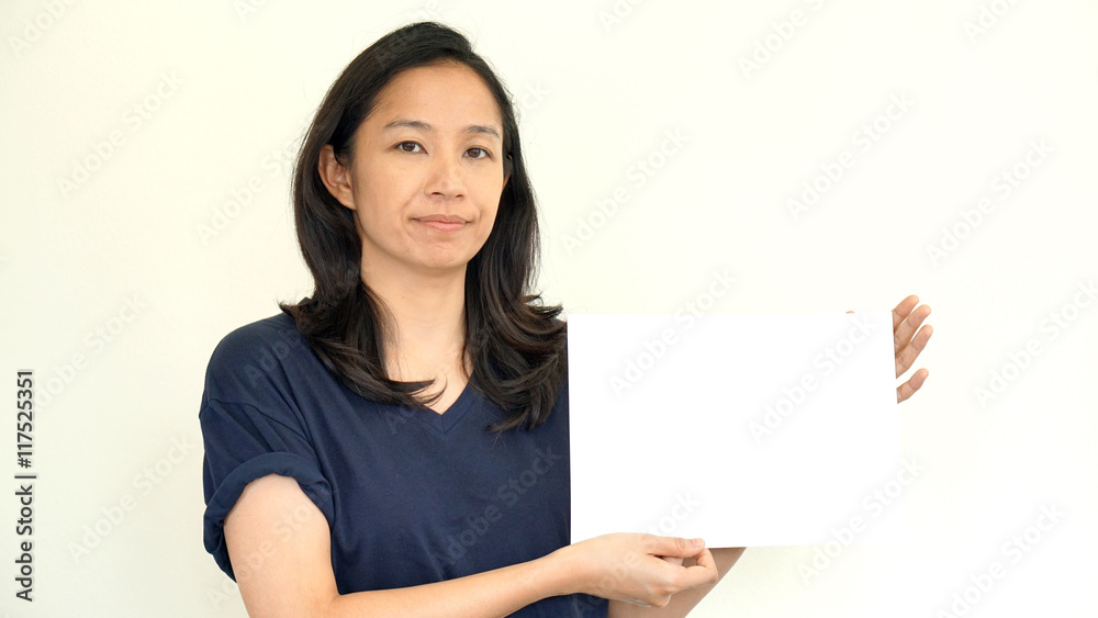 South East Asian girl casually holding while sign for copy space South East Asian girl casually holding while sign for copy space