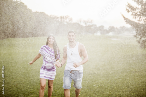young couple in love having fun and enjoying the beautiful nature.Young couple in the rain