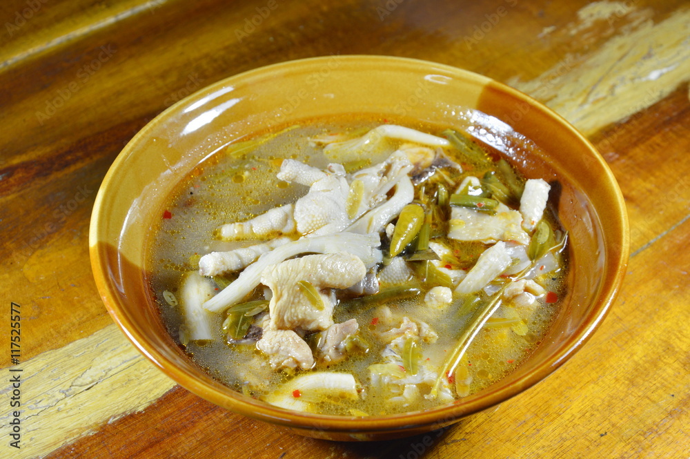 chicken feet with tamarind leaf spicy soup on bowl chicken feet with tamarind leaf spicy soup on bowl