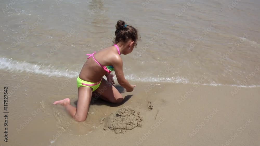 Child Playing in Sea Sand Beach, Little Girl on Tropical Exotic Sea Coastline Child Playing in Sea Sand Beach, Little Girl on Tropical Exotic Sea Coastline