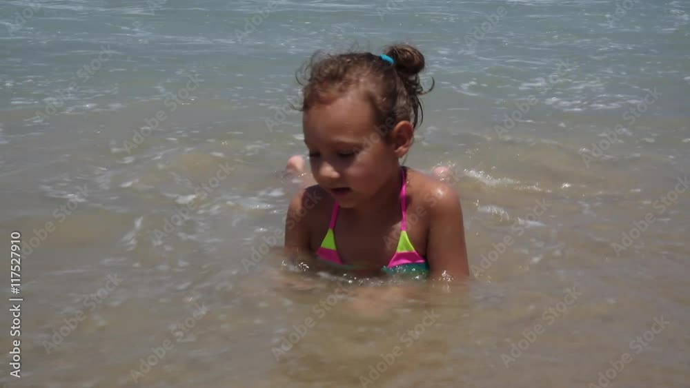 Child Playing in Sea Sand Beach, Little Girl on Tropical Exotic Sea Coastline Child Playing in Sea Sand Beach, Little Girl on Tropical Exotic Sea Coastline