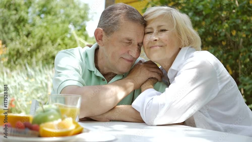Man and woman sitting in the garden and smile. Man and woman sitting in the garden and smile.