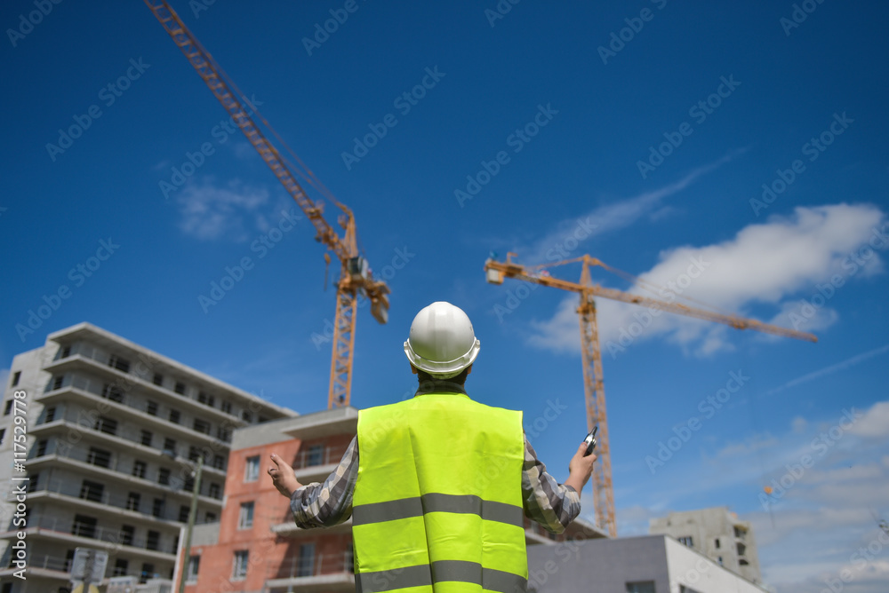 Foreman using walkie-talkie on construction site Foreman using walkie-talkie on construction site
