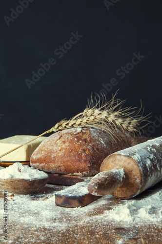 Bread and additions on a wooden table