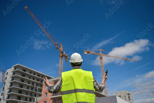 Foreman using walkie-talkie on construction site