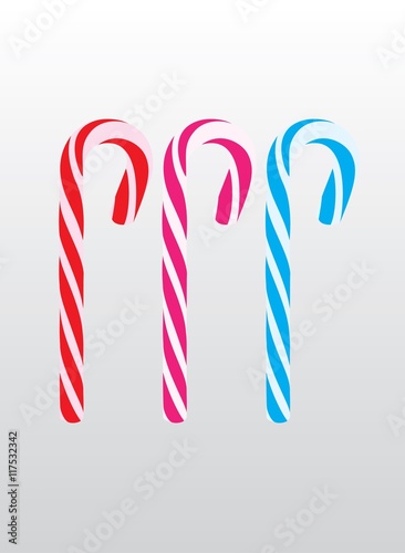 Delicious red, pink and blue lollies pop on grey background
