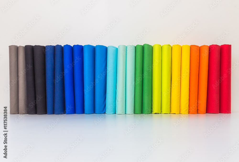 Stack of colorful spectrum t-shirts, folded 2 for each color t-shirts on white background.