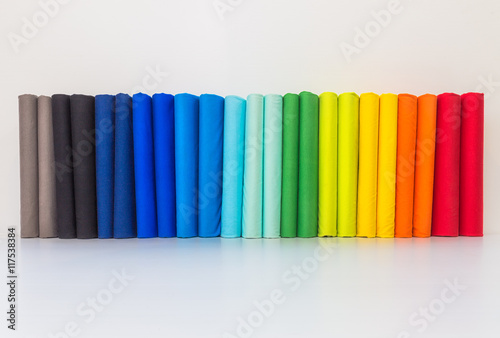Stack of colorful spectrum t-shirts, folded 2 for each color t-shirts on white background.