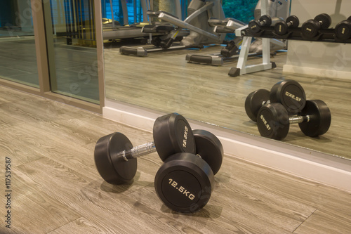 weight body building with Sports dumbbles,Dumbbells in the fitness room.