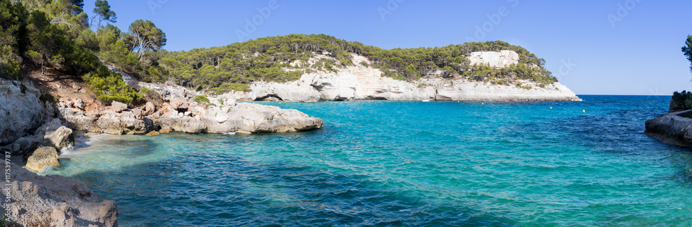 Panoramic view of a bay with crystal blue water with cliffs Panoramic view of a bay with crystal blue water with cliffs