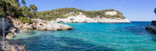 Panoramic view of a bay with crystal blue water with cliffs