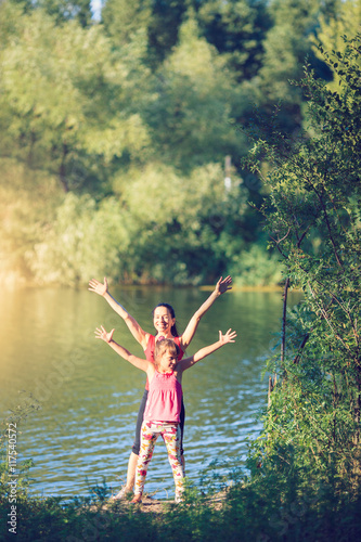 Wallpaper Mural family workout - mother and daughter doing exercises on beach. Torontodigital.ca