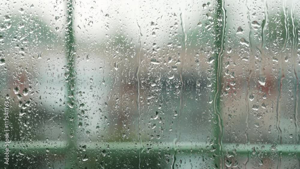 real rain drops sliding on window glass