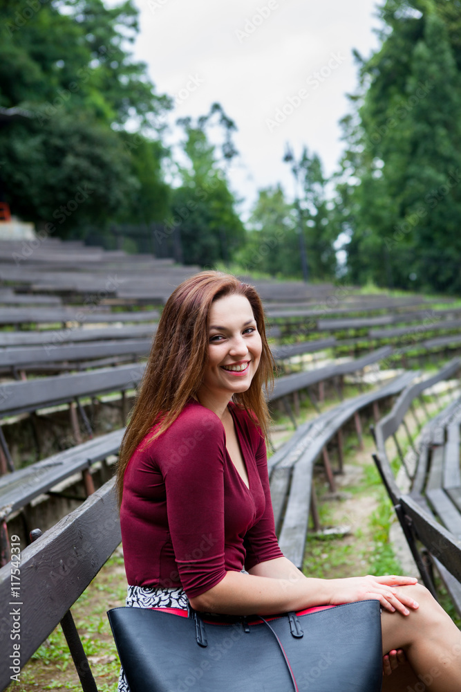Young beautiful girl sit on a banch
Young beautiful girl sit on a banch
