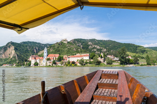 View of town of Durnstein with abbey and old castle from ferry on Danube river, Wachau valley, Lower Austria