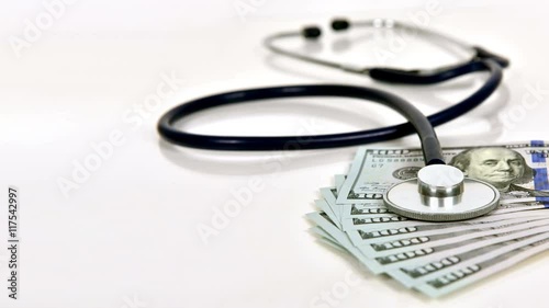 Stethoscope And Money On A White Background. Slow Motion Effect