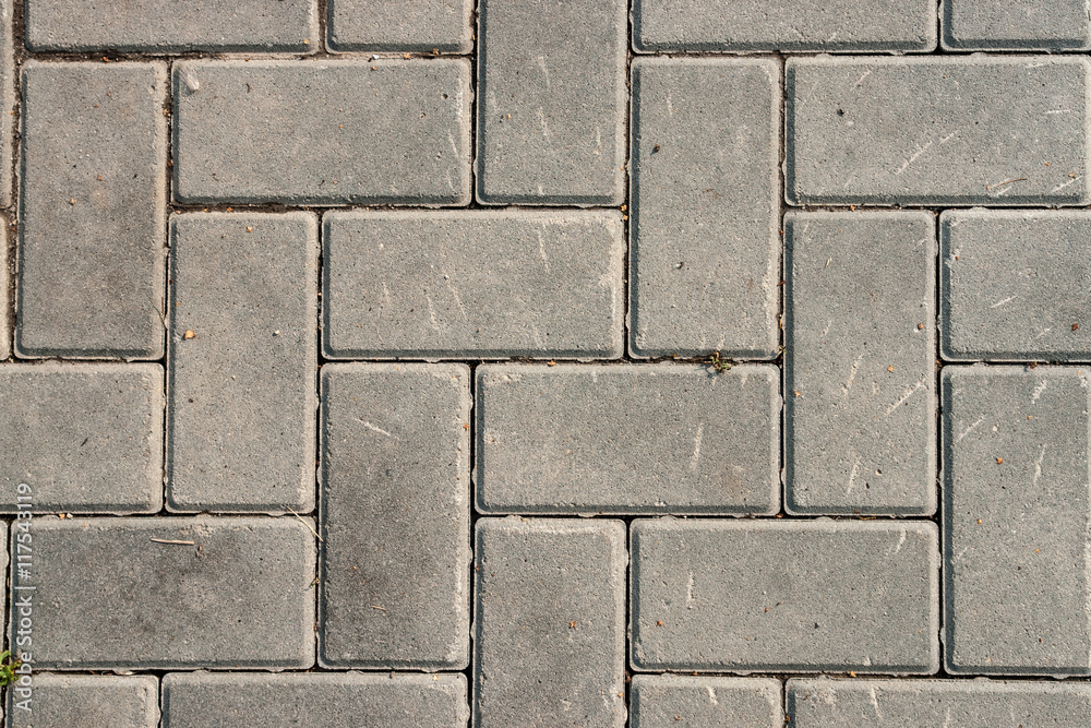 Naklejka premium Grey brick stone street road. pavement texture