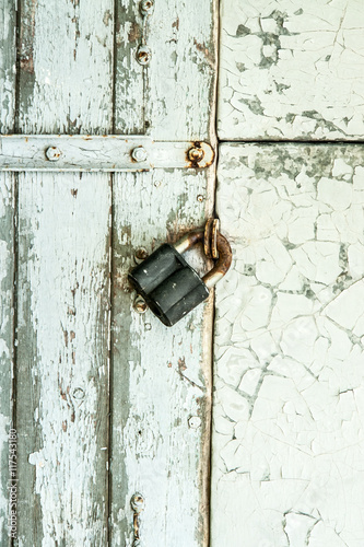 White wooden wall door with the metal lock