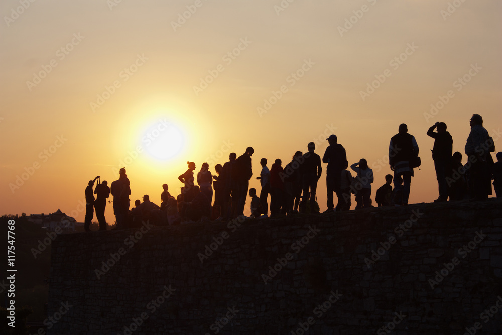 silhouette of people on a sunset background