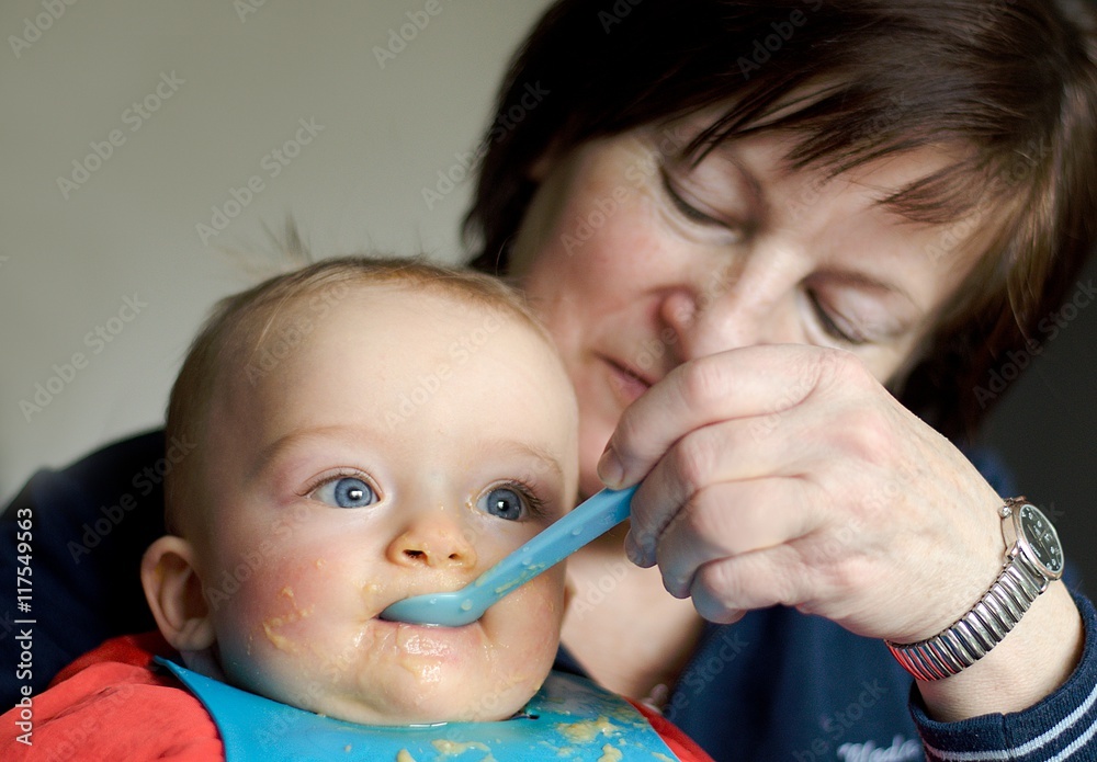 Portrait of mum which is feeding baby. She is looking at him lovingly. Portrait of mum which is feeding baby. She is looking at him lovingly.