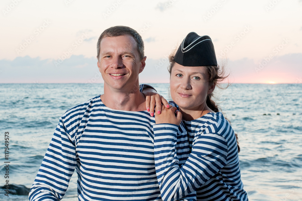 man with a woman standing on the background of the sea