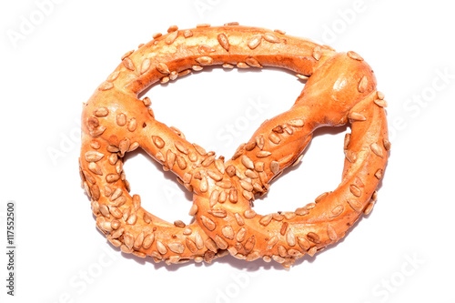Fresh pretzel with seeds isolated on white