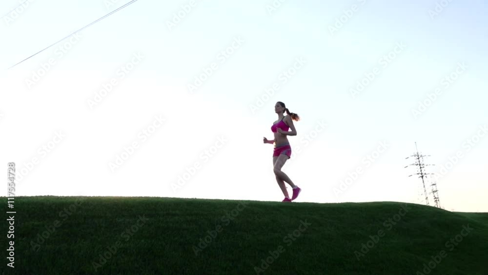 Woman running in nature park summer nature sun path alone on road. Slow motion Woman running in nature park summer nature sun path alone on road. Slow motion