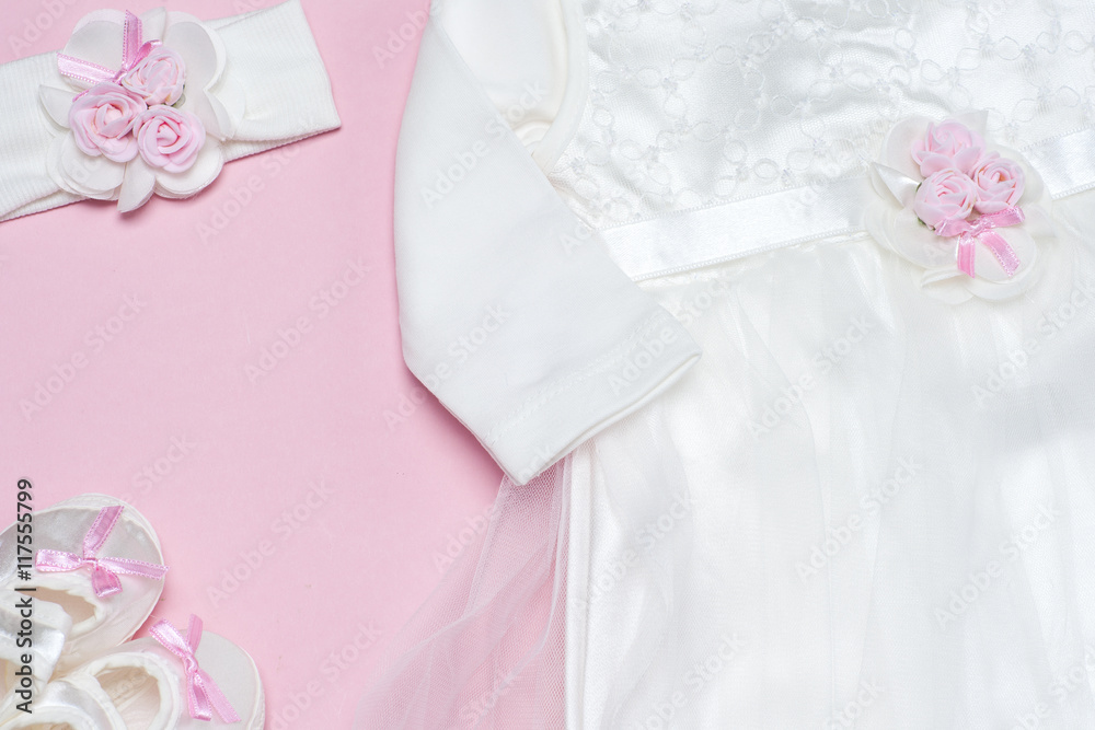 Clothes for baby girl on a pink background. Copy space for text