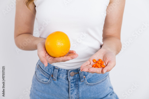 Girl with orange and pills