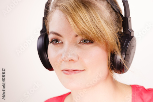 Woman in big headphones listening music