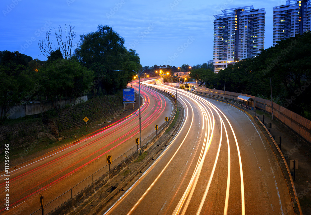 Light trails of cars at highways during blue hour.