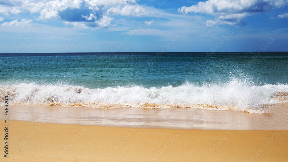 Turquoise sea wave foam on sand beach, blue sea, sky and nice cloud in summer time. Turquoise sea wave foam on sand beach, blue sea, sky and nice cloud in summer time.