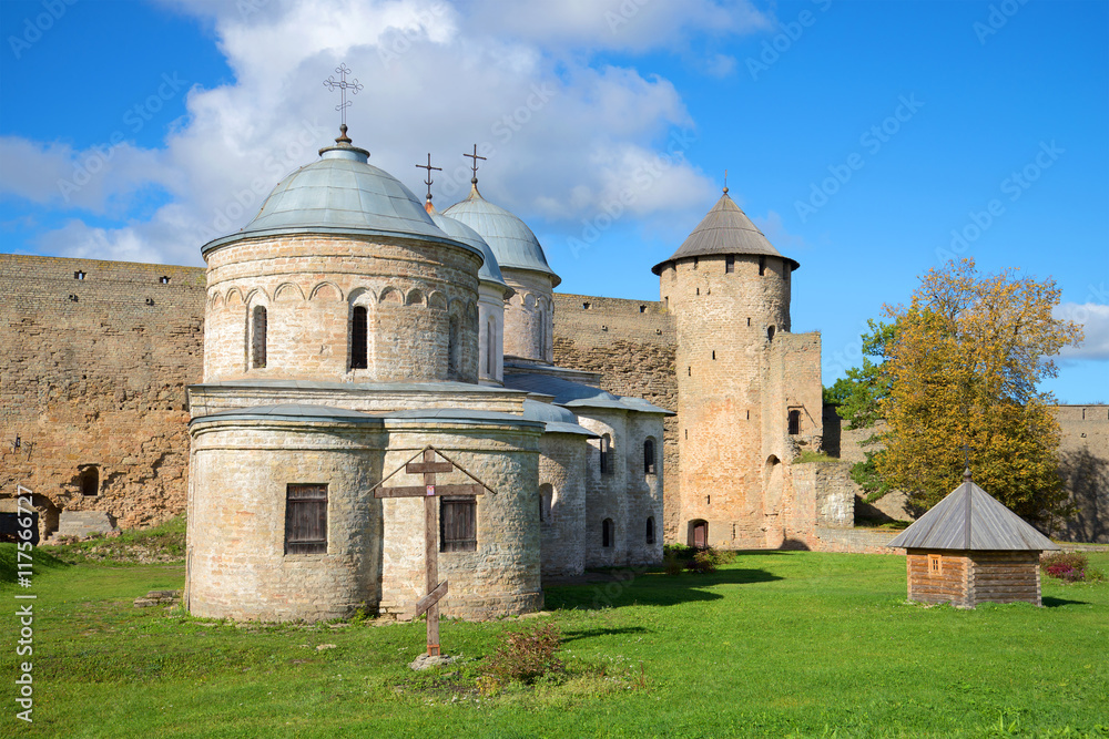 Two old medieval Church and tower, sunny september day. Ivangorod fortress, Russia