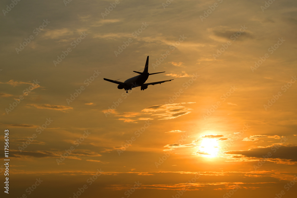 The plane flies in the sky at sunset The plane flies in the sky at sunset
