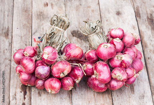 Red onions group on grunge texture wooden background,Shallot onions on wooden