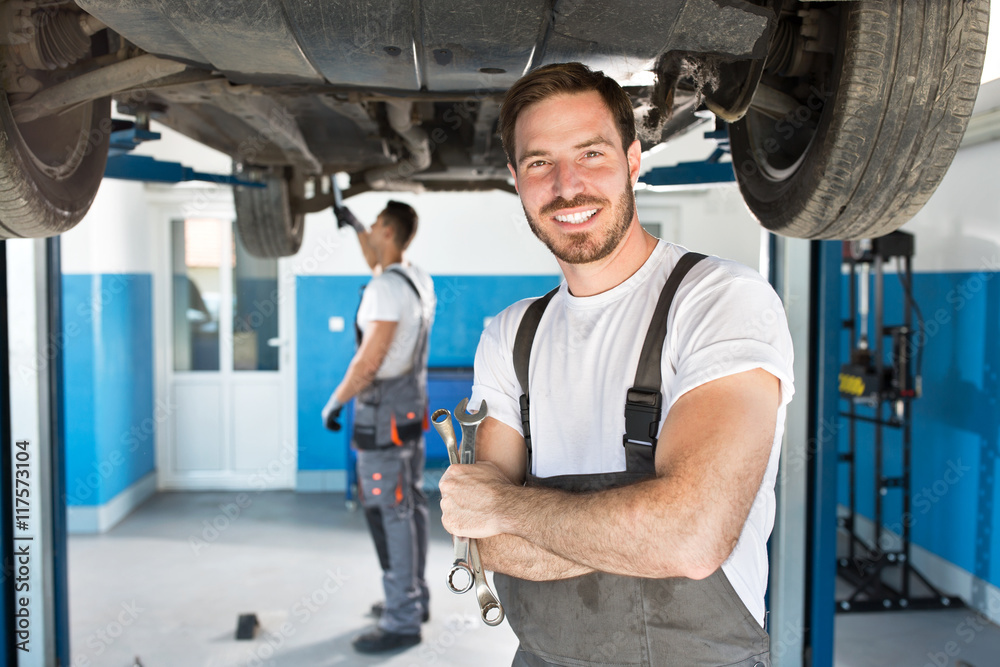 Smiling mechanic with tools