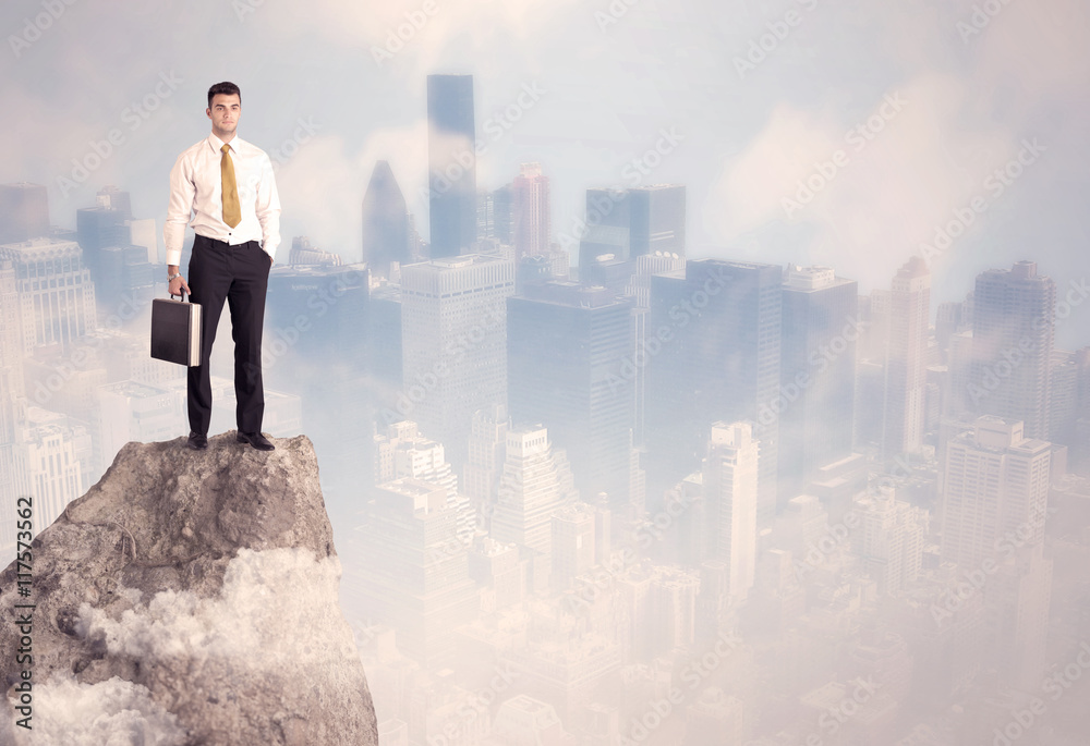Winner urban businessman on top of stone Winner urban businessman on top of stone